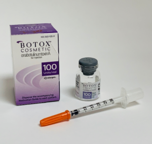 Photograph of a Botox vial, syringe, and packaging.