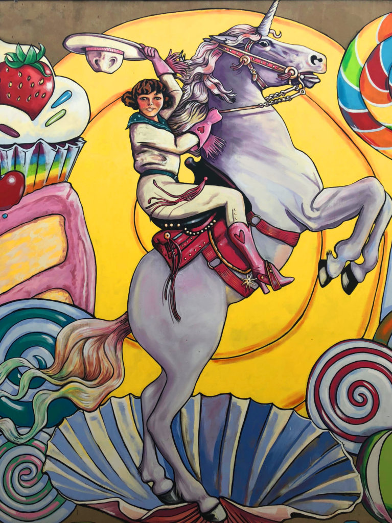 Mural of a cowgirl on a unicorn in Inspiration Alley in the Fort Worth Foundry District