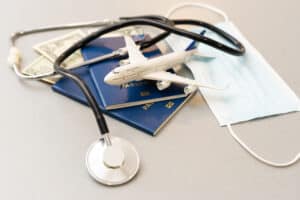 Passport, stethoscope and toy plane.