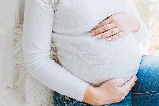 image of a pregnant woman in a white shirt