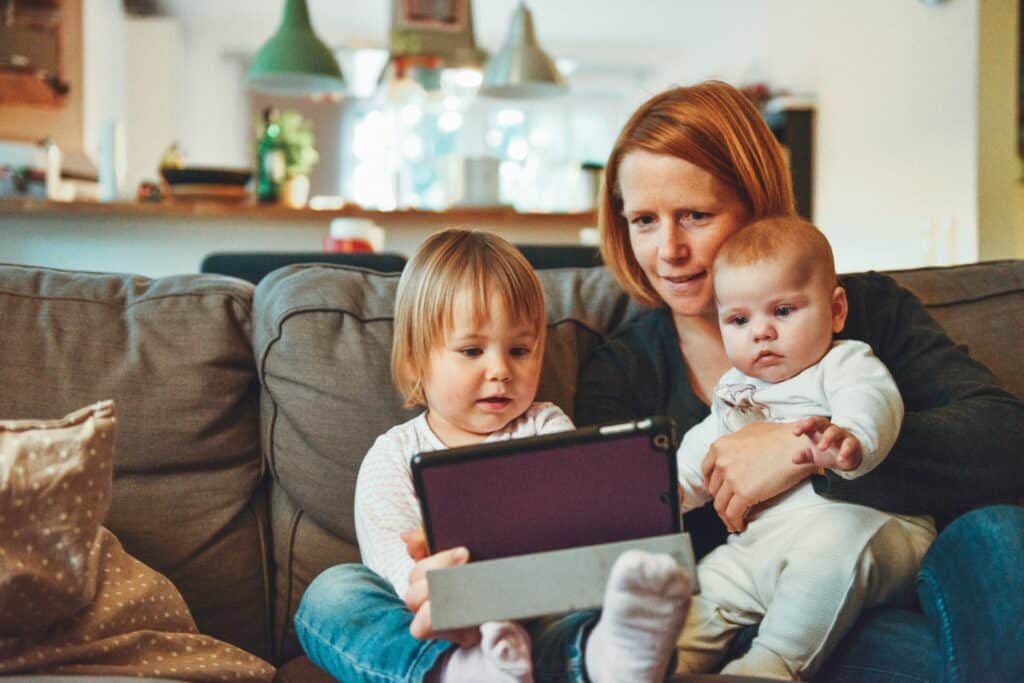 Photo of a woman with 2 toddlers; a good candidate for a mommy makeover.