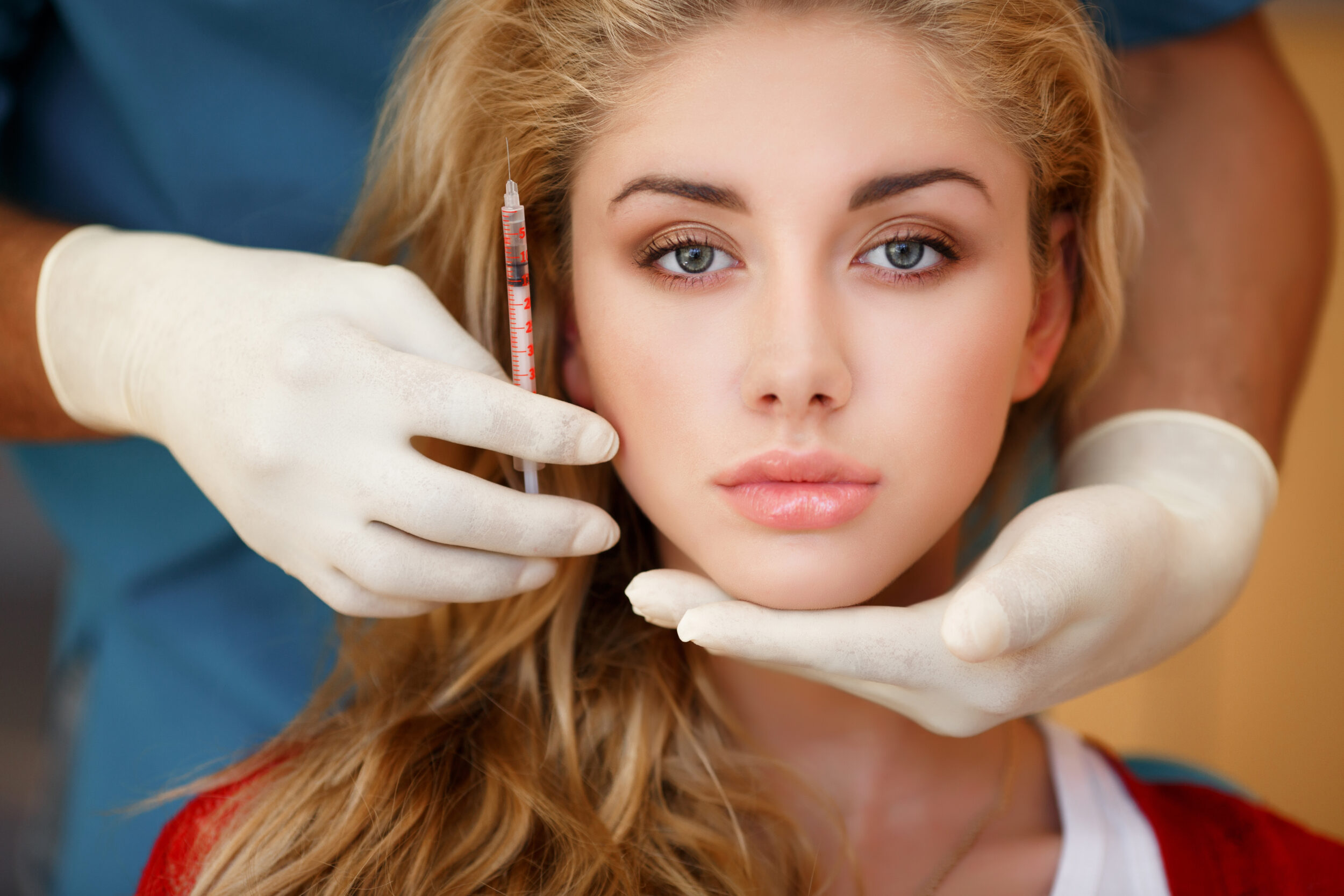 Doctor cradles woman's beautiful voluminous face after a Restylane injection